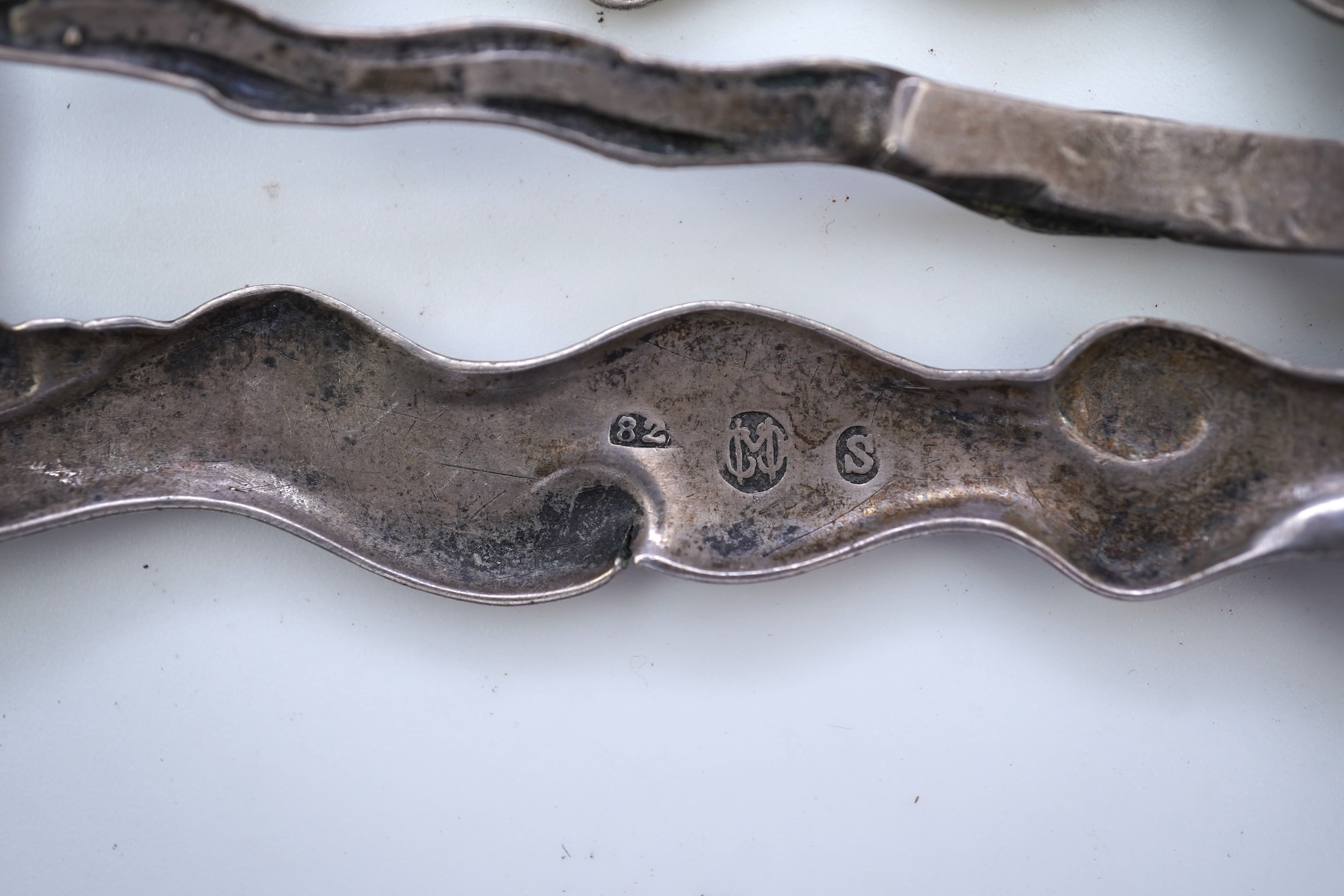 An Arts & Crafts silver slide and three silver brooches, probably Denmark, first half 20th century